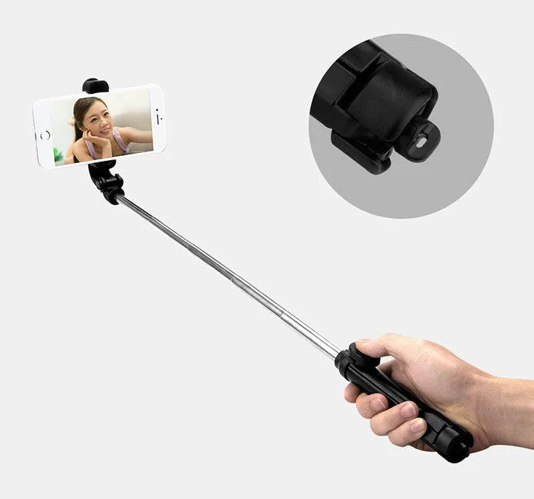 Compact black aluminium Bluetooth selfie stick with integrated tripod legs and a 360-degree rotating phone clip.