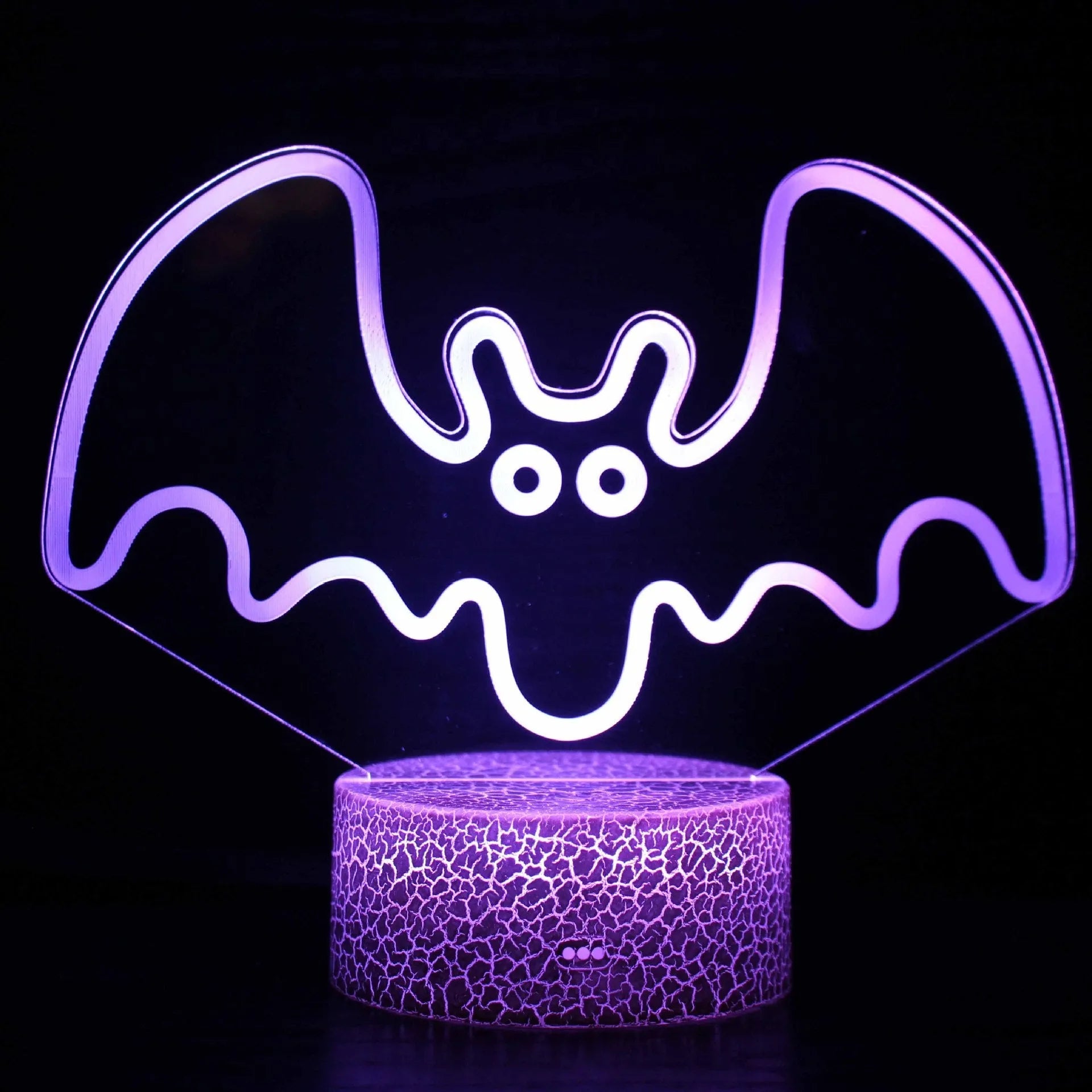 Small blue 3D acrylic USB table lamp with cracked base design lit up on a wooden desk.