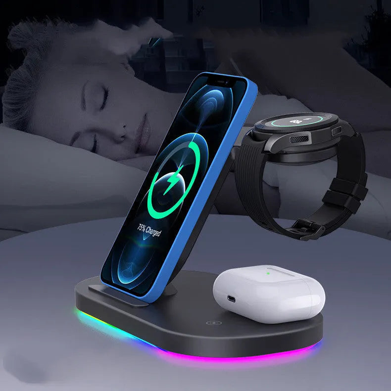 Black three-in-one wireless charging station with phone, watch and accessory on charging surfaces