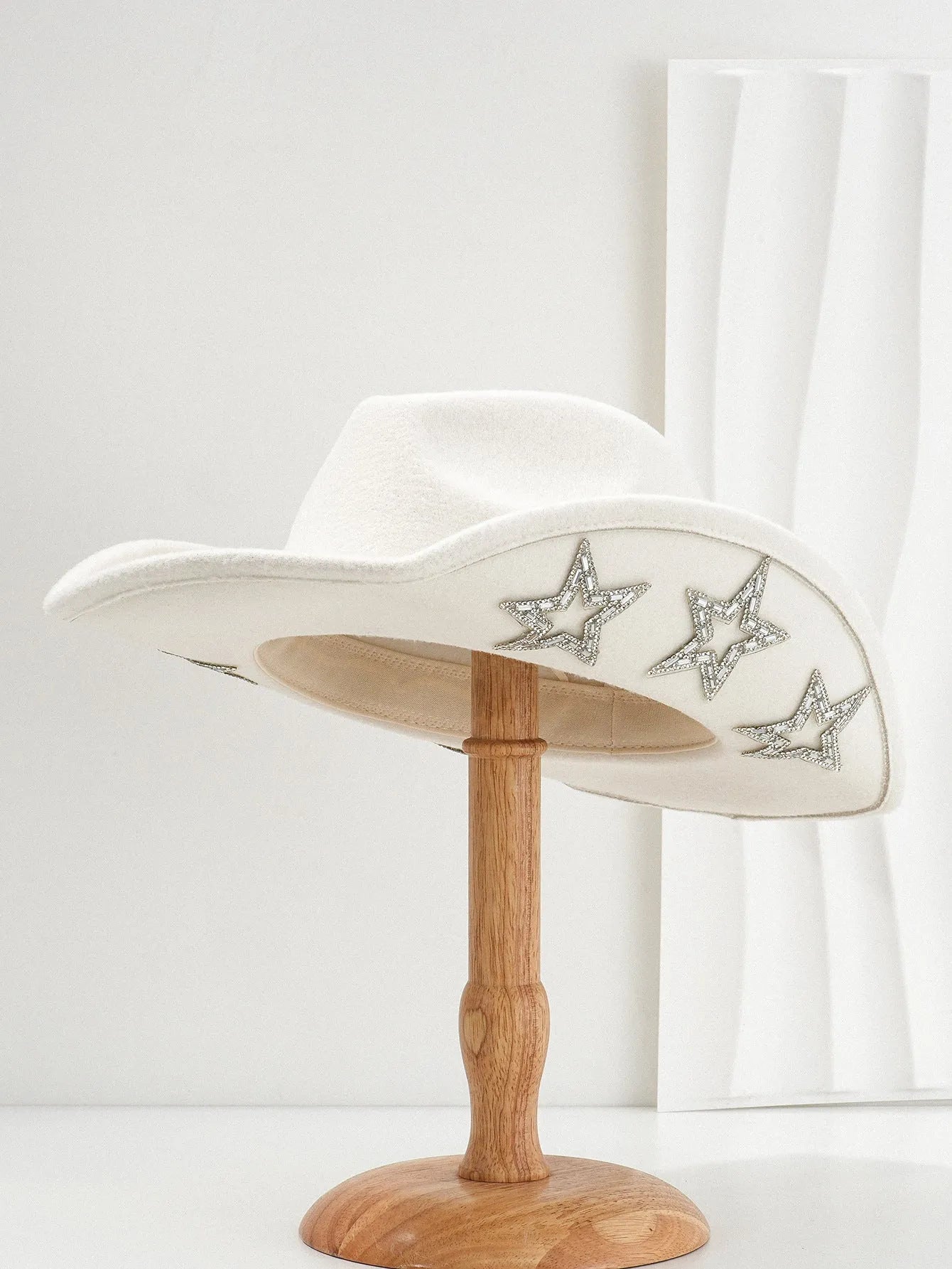 Beige woven polyester western top hat with a conical crown and a hexagonal star decoration on the front.