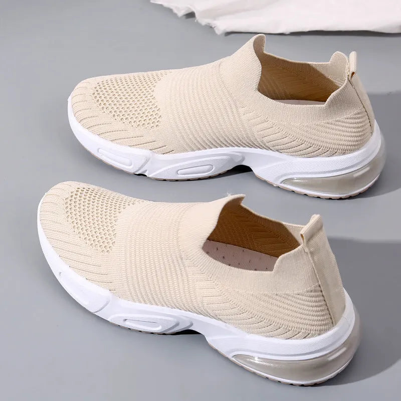 Lightweight black slip-on sock shoes with a low-top design and textured PVC sole.