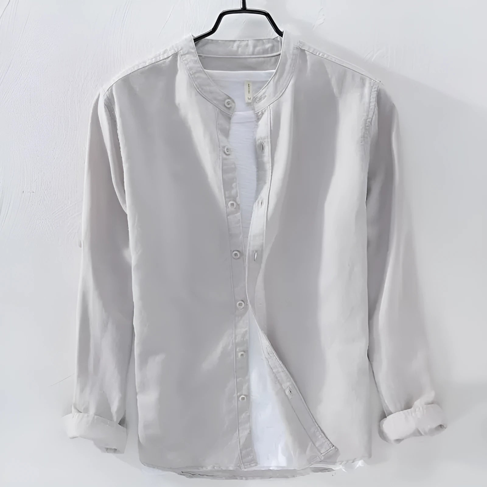 A man's loose-fitting, long-sleeve casual shirt in a cotton linen blend, shown in a solid colour.