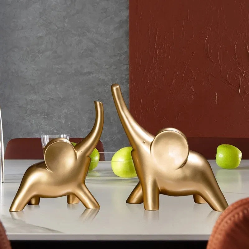 Modern minimalist elephant figurine ornament in rose gold or white resin on a plain background.