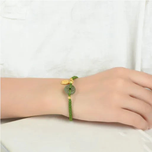Green rope bracelet with Hetian jade peace buckle fastener, traditional Chinese hand-woven construction