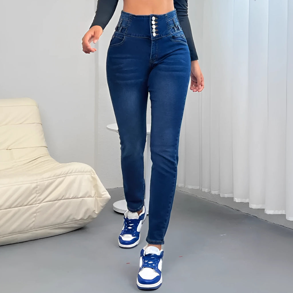Dark blue women's straight-leg denim trousers with button and zipper details on a hanger.