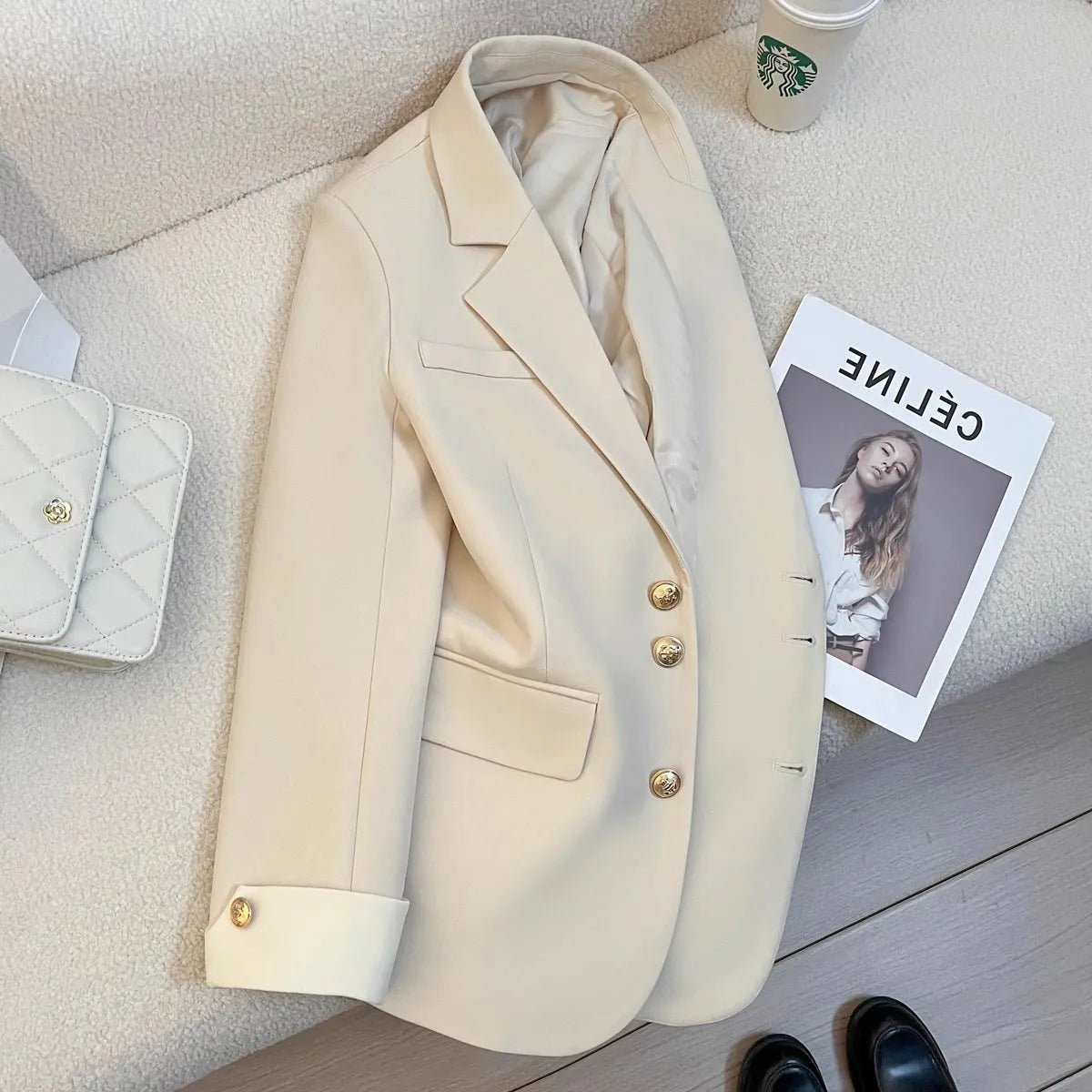 Women's loose fit Korean style coat in milky white, showing long sleeves and pockets.