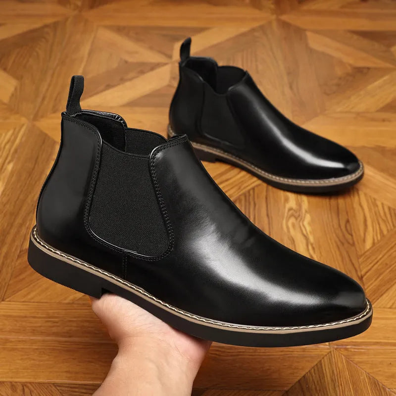 Black formal leather pointed-toe boots with a square heel and rubber sole on a white background.