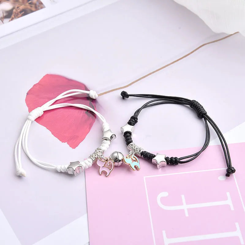 Magnet suction couple bracelets with alloy construction and various pendant designs including crowns and hearts