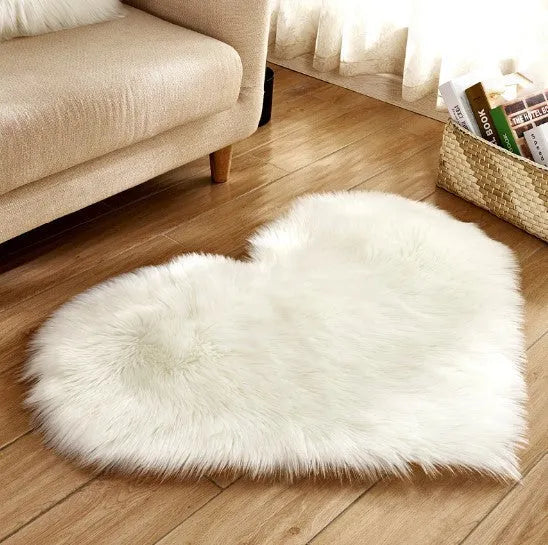 Heart-shaped plush carpet in multiple colours showing wool-like texture with 5-6 cm pile length