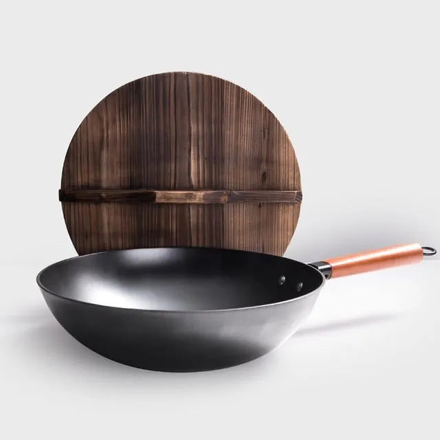 Traditional black cast iron wok with a long wooden handle, shown with a glass lid.