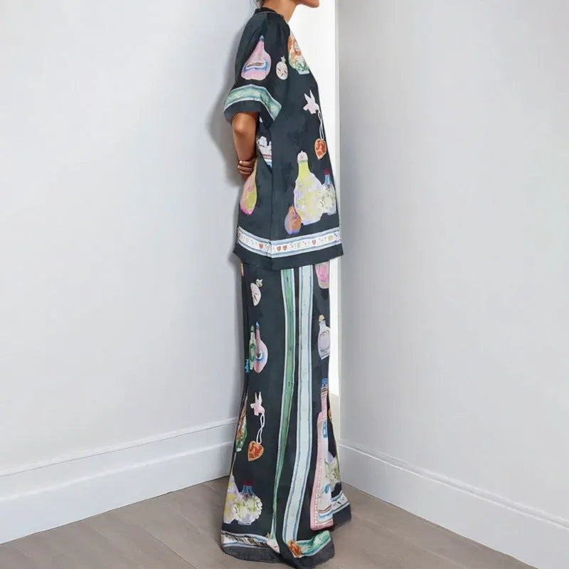 Black women's co-ord set with cartoon animation print, featuring a cardigan and trousers.
