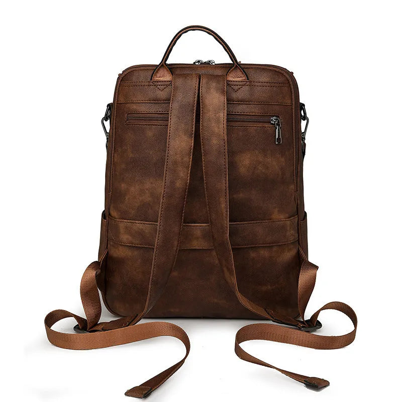Retro solid colour PU backpack with curved shoulder straps shown in black.