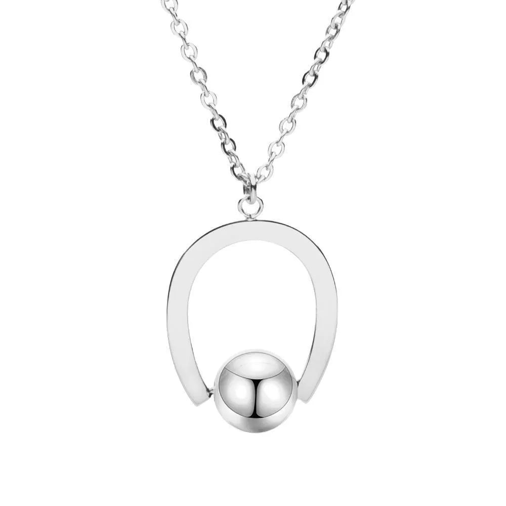 Gold tone stainless steel necklace with geometric pendant on a cross chain, shown adjusted to a medium length.