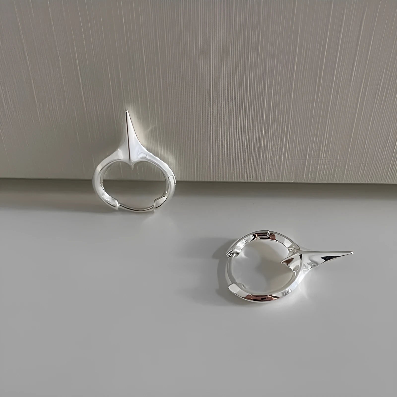 Platinum coloured geometric star shaped ear clips for women with a white gold plated finish