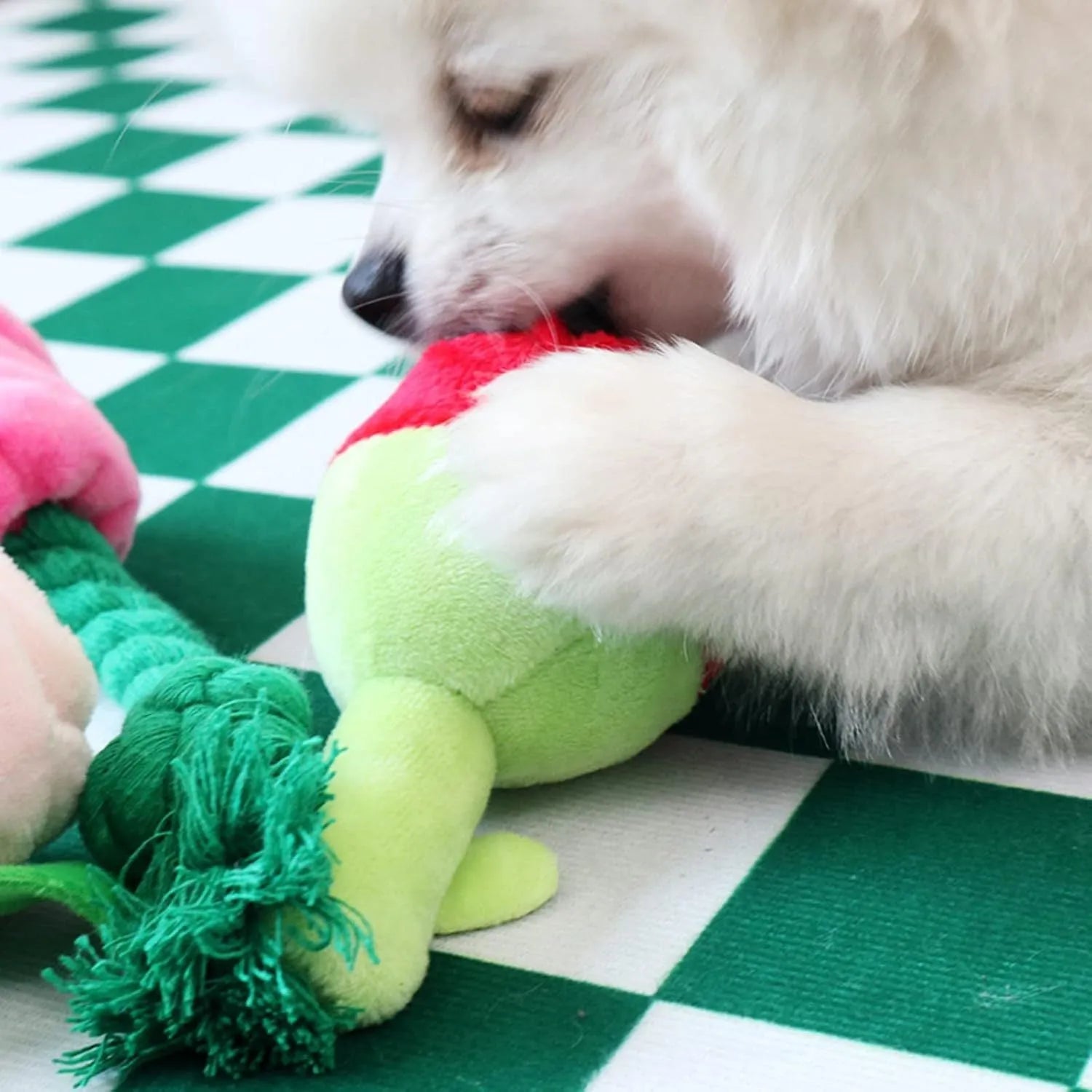 Plush pink rose flower dog chew toy with green leaf and a squeaker inside.
