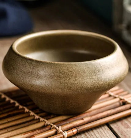 Tall porcelain ceramic Japanese soup bowl with underglaze vintage pattern on wooden table.