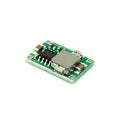 Mini-360 green DC-DC buck converter step-down power module on white background