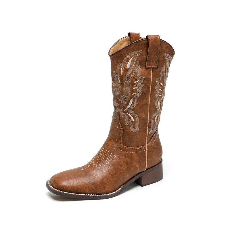 Brown women's mid-calf boots with embroidered pattern, round toe, and low square heel on a rubber sole.