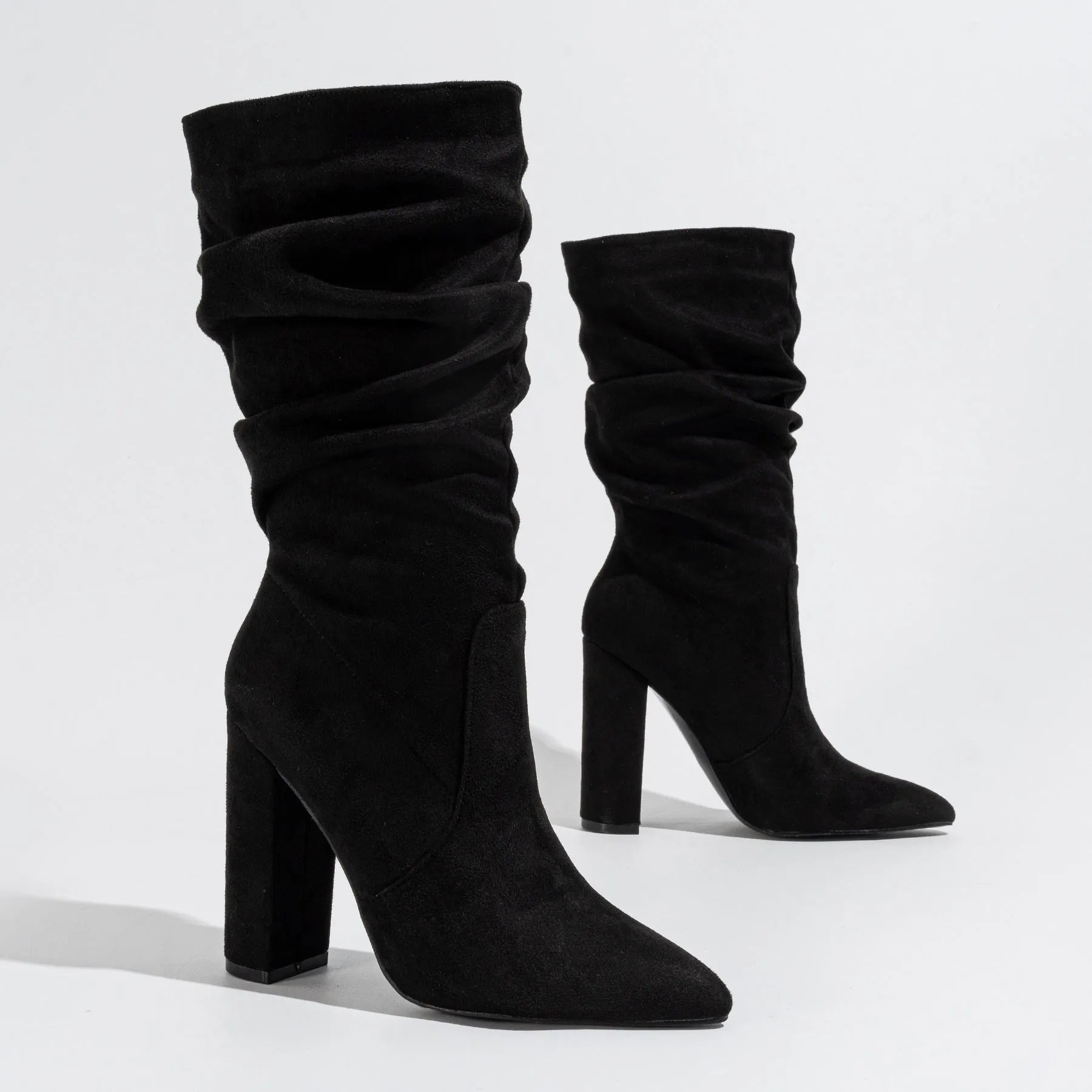 Black suede women's boots with a chunky high heel and pointed toe.