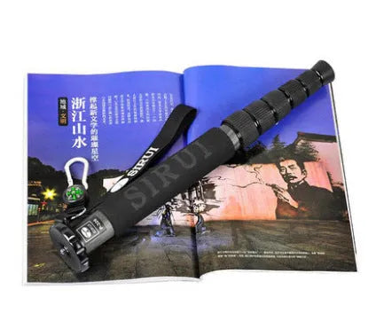 Black carbon fibre six-section SLR camera monopod extended to its maximum height.