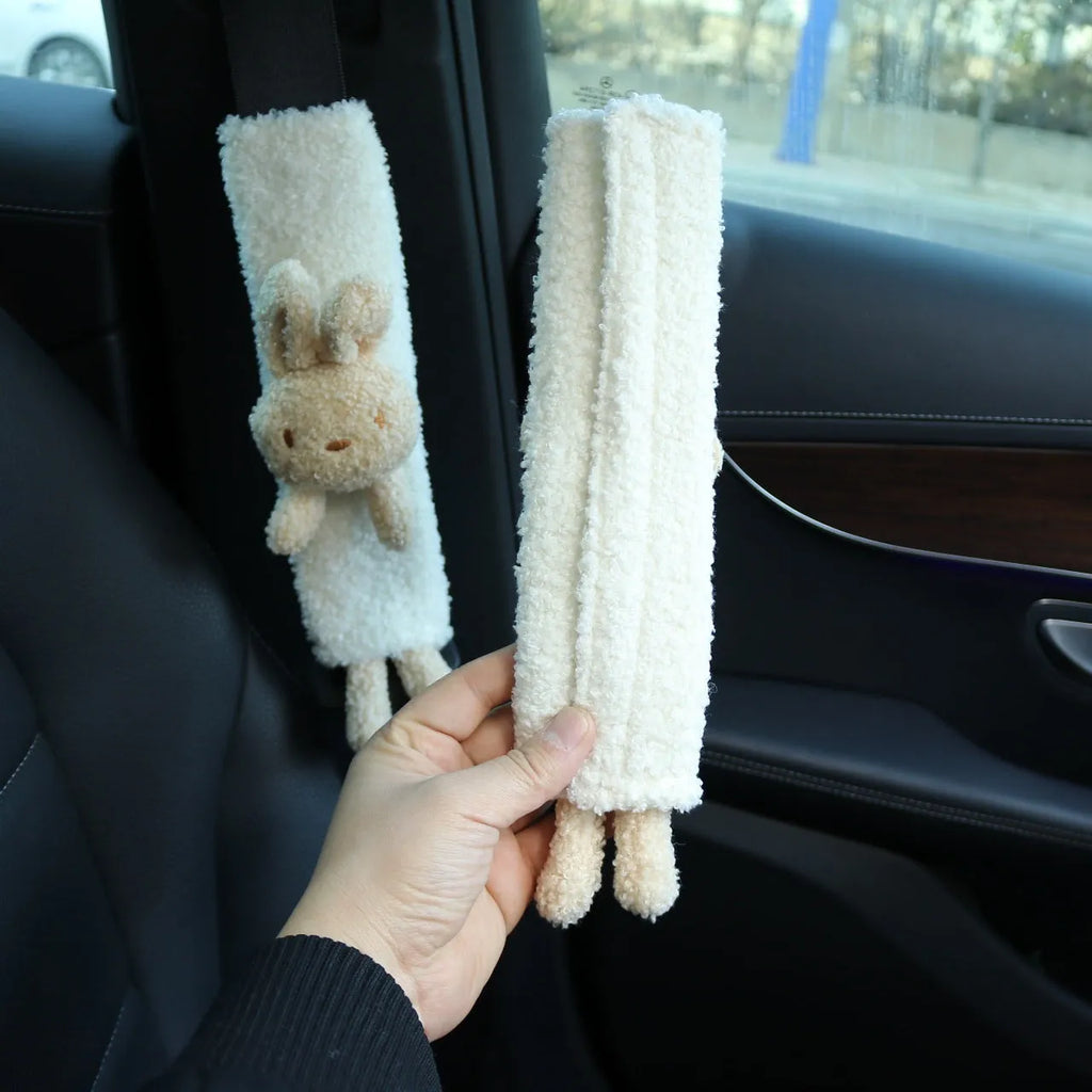 Cartoon plush seat belt shoulder protector in lamb wool with bear and rabbit designs.