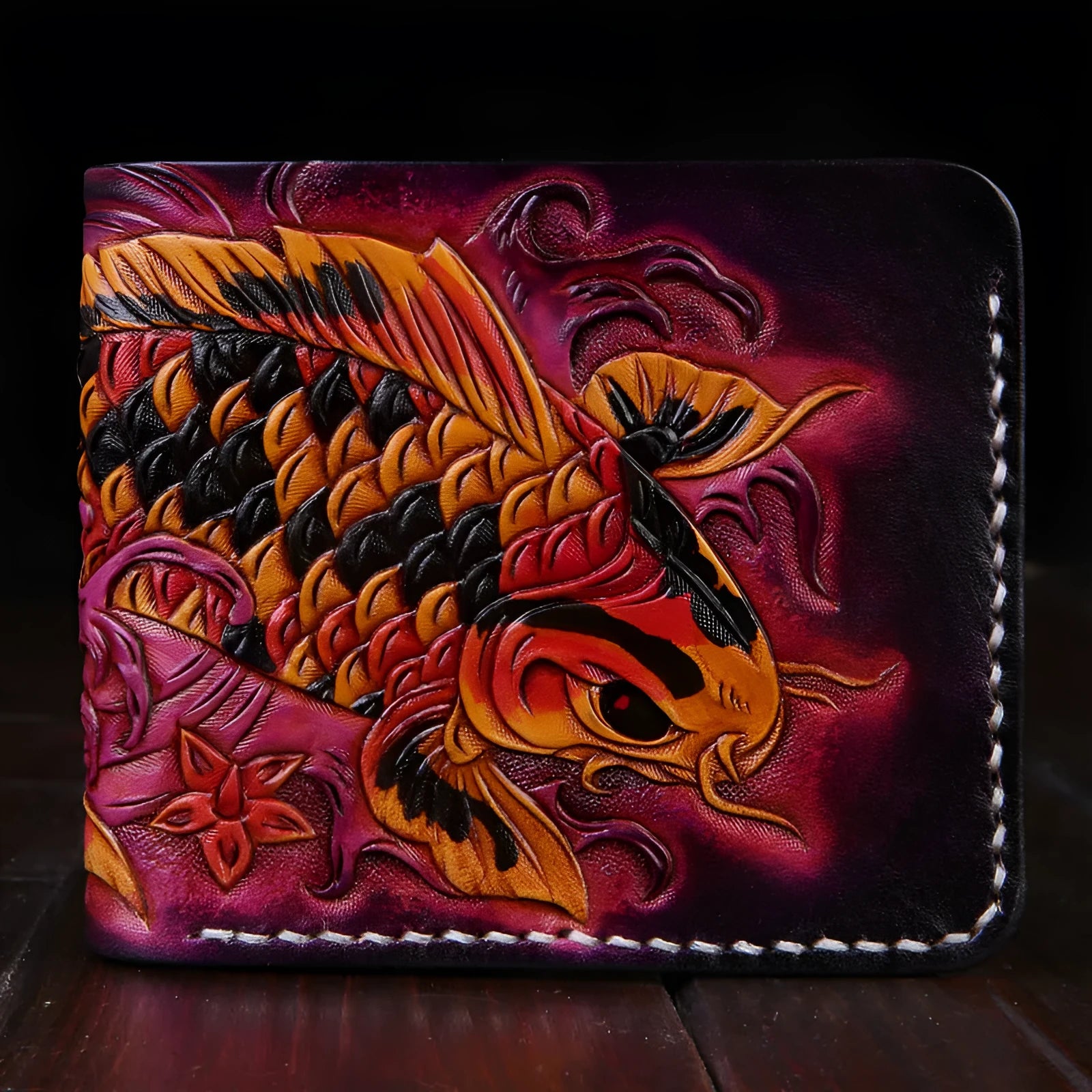 Men's blue hand-carved leather bifold wallet showing card slots and note compartment, placed on a wooden surface.