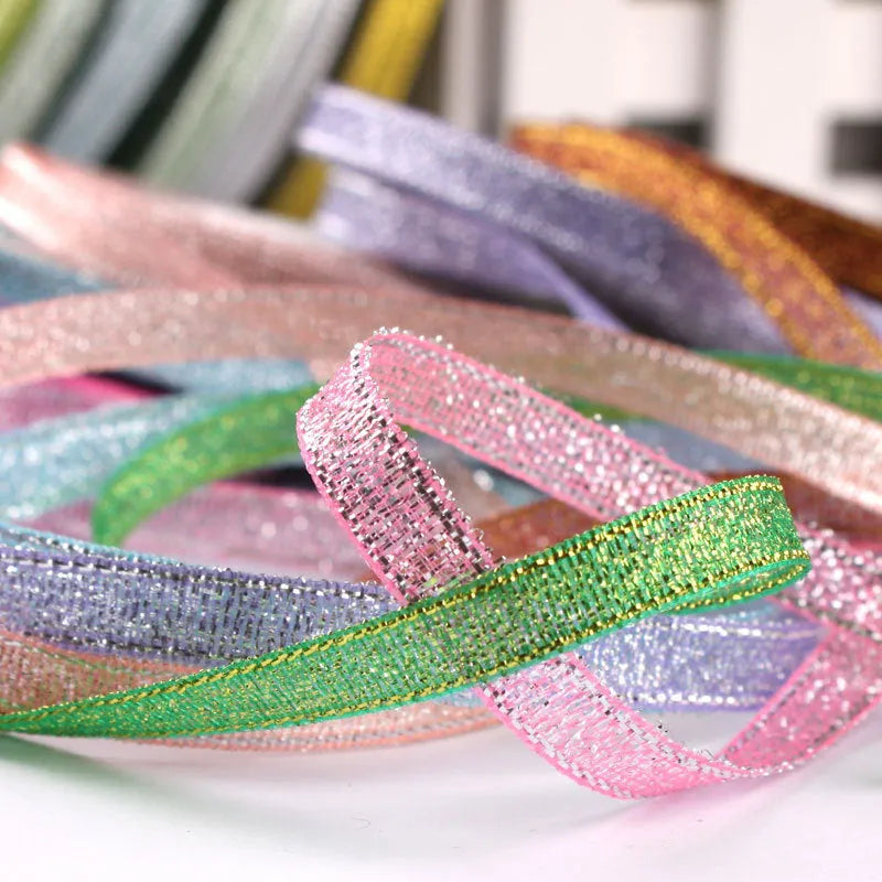 Roll of narrow 0.6cm wide polyester gift ribbon in a multicolour pattern.