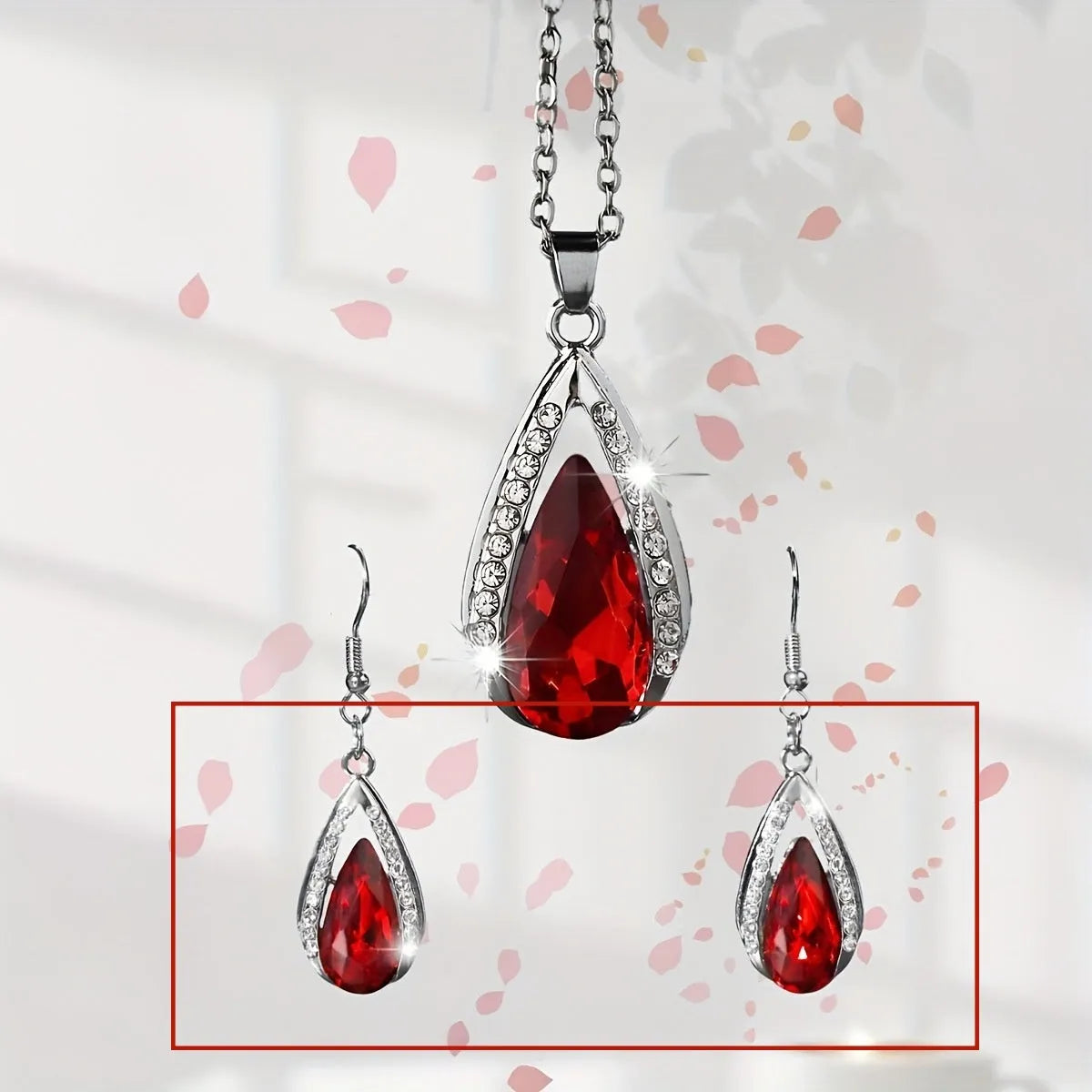 Alloy teardrop glass pendant necklace and matching earrings set in black or red.