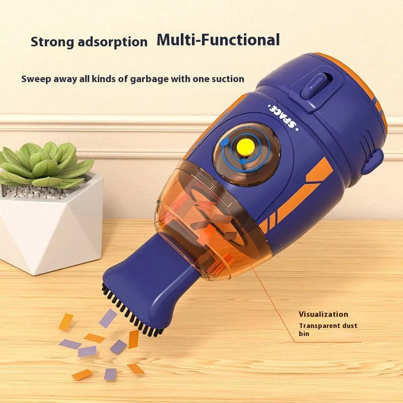 Handheld USB desktop vacuum cleaner in blue rocket design on a wooden desk next to a keyboard