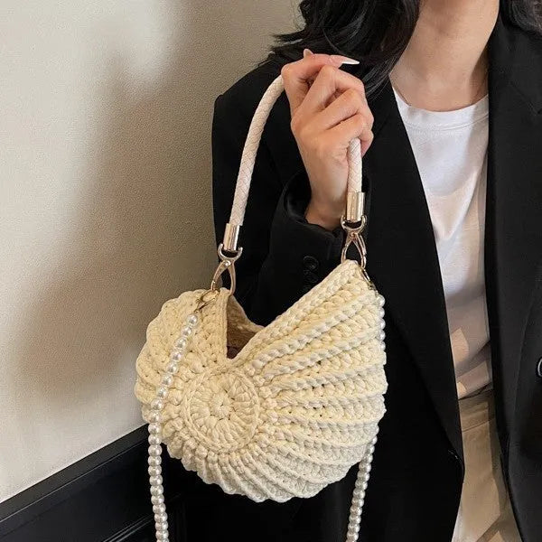Handmade woven cloth bag in retro style with open pocket and double shoulder straps.