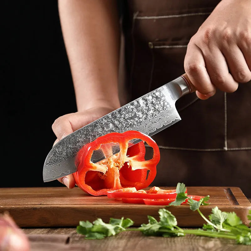 Damascus steel kitchen knife set of 7 with patterned blades and wooden handles on a dark surface