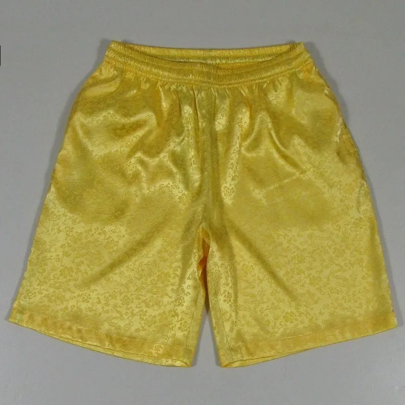 Man wearing traditional black Tang suit style Tai Chi shorts with an elastic drawstring waistband.