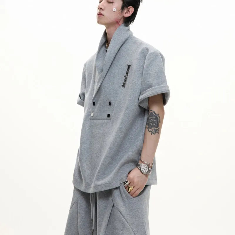Men's dark grey cotton sports suit with padded shoulders, featuring a V-neck short-sleeve shirt and matching shorts.