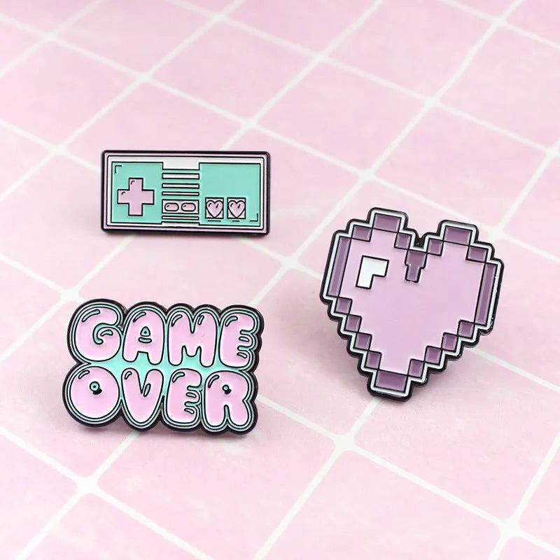 Solid alloy metal game console badge pin on a clear OPP packaging background.