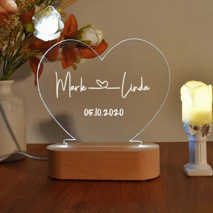 Custom acrylic LED night light with engraved names and date for Valentine's Day.