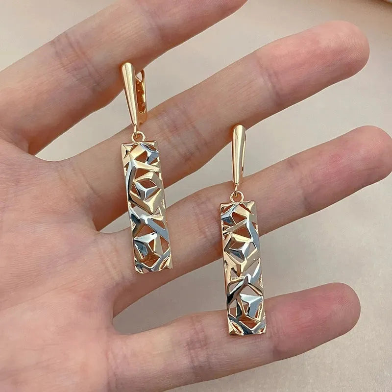 A pair of rectangular two-tone hollow stud earrings with an electroplated picture-style finish.