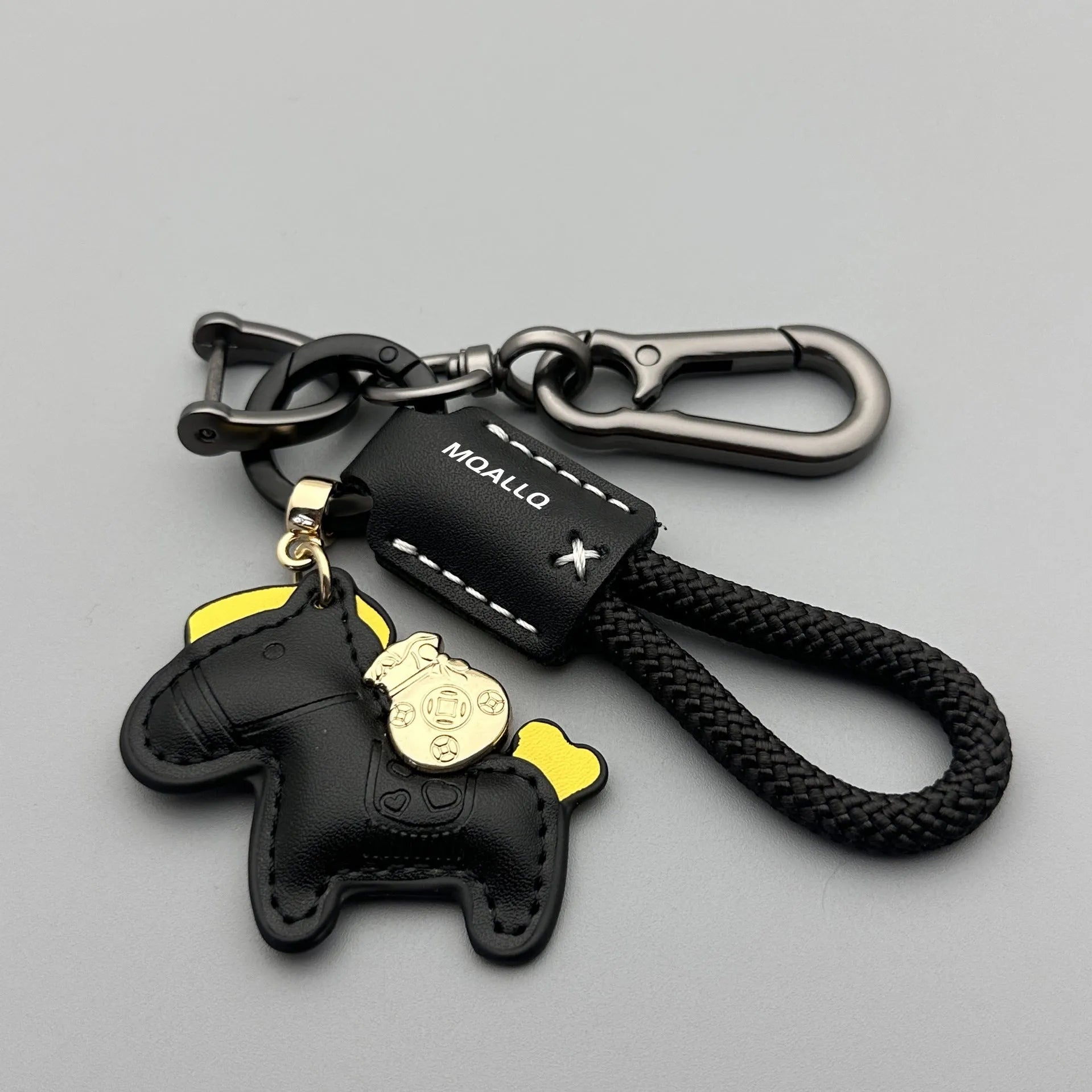 Handmade brown cowhide leather key ring with a zinc alloy pendant charm on a green flannel rope.