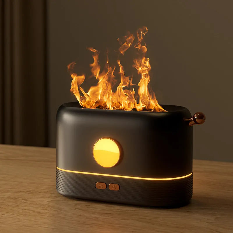 Black USB humidifier with simulated flame effect on a wooden desk.