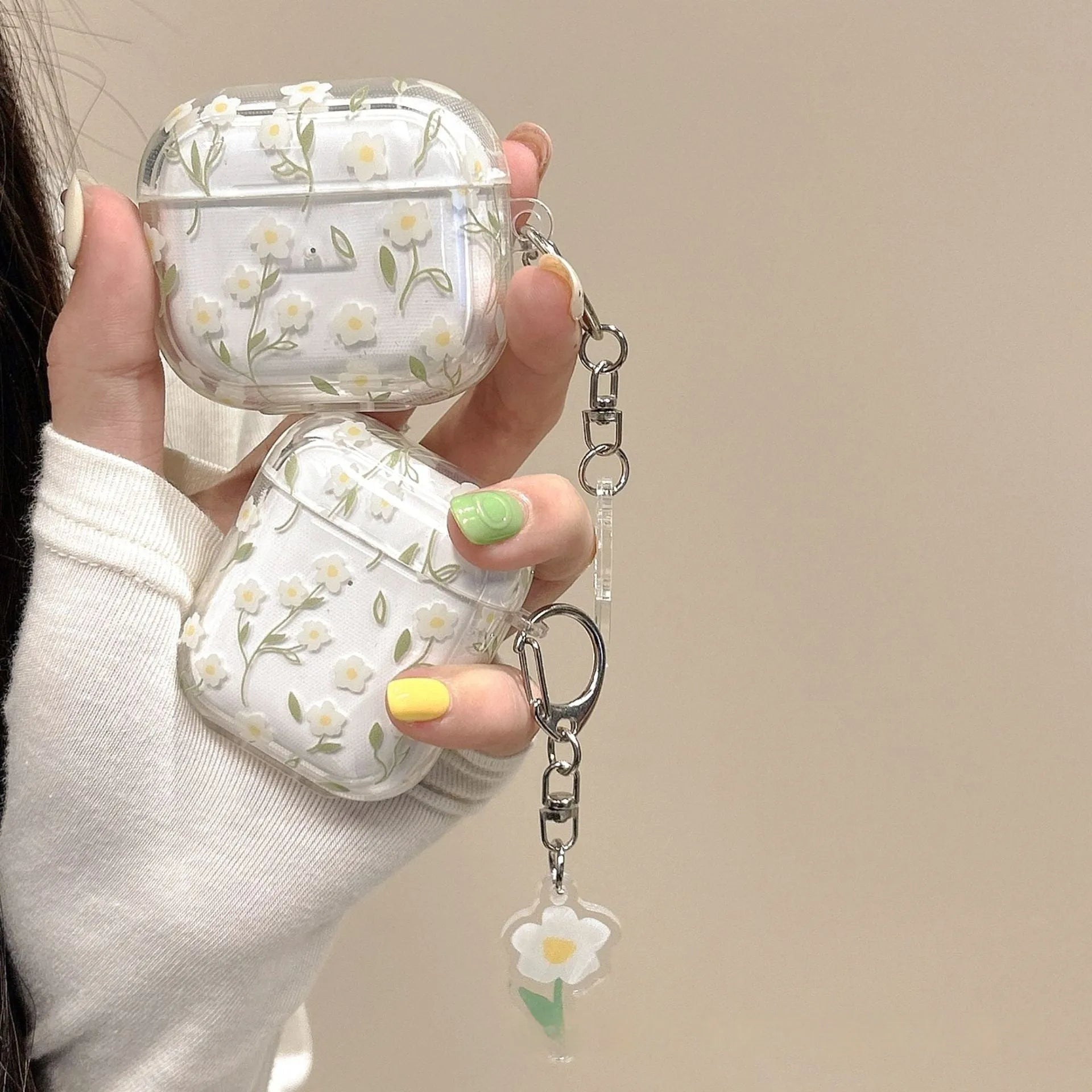 White floral pattern clear TPU protective case for Apple AirPods on a charging case.