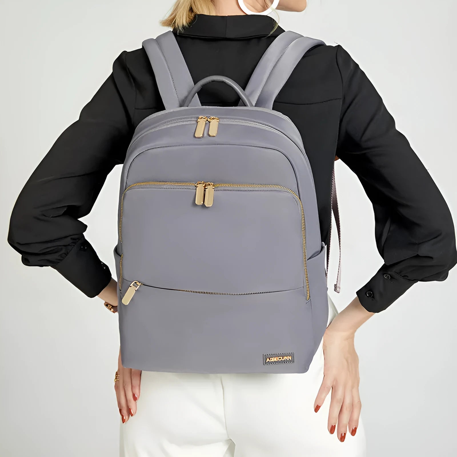Large black oxford cloth women's backpack with anti-theft compartments and padded straps.