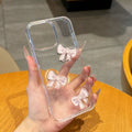Transparent silicone iPhone case with pink bow knot and clear drop-resistant cover.