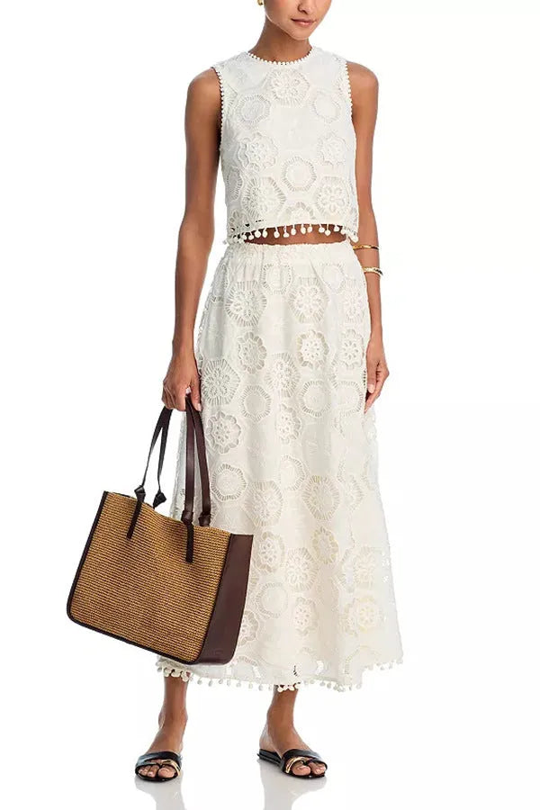 Literary Trends white women's suit with embroidered long skirt and sleeveless top on a hanger