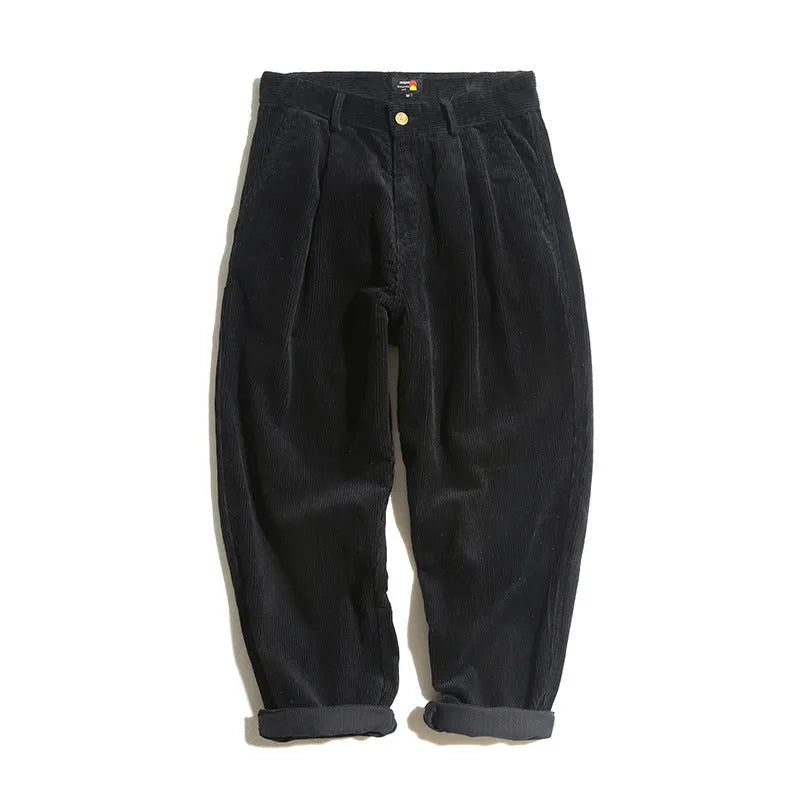 Men's straight-leg corduroy trousers in army green, showing front zipper fly and textured fabric.