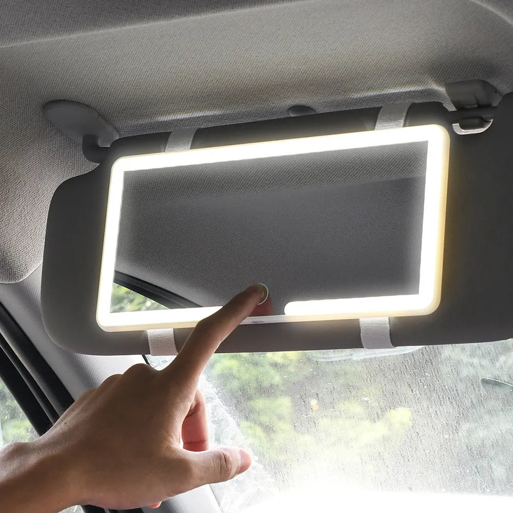 Black automotive sun visor makeup mirror with LED light and dimming control, shown with data cable