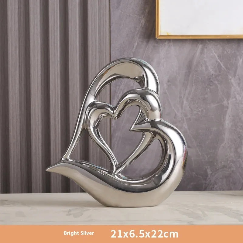 Modern geometric heart ornament in metallic finish displayed on shelf