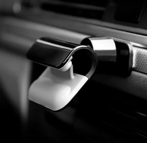 Black universal car phone holder with 360-degree rotation on car dashboard