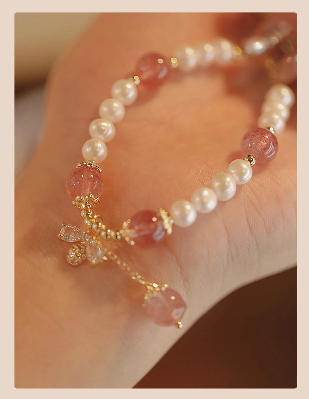 Strawberry quartz crystal bead bracelet for women with a central bow decoration.