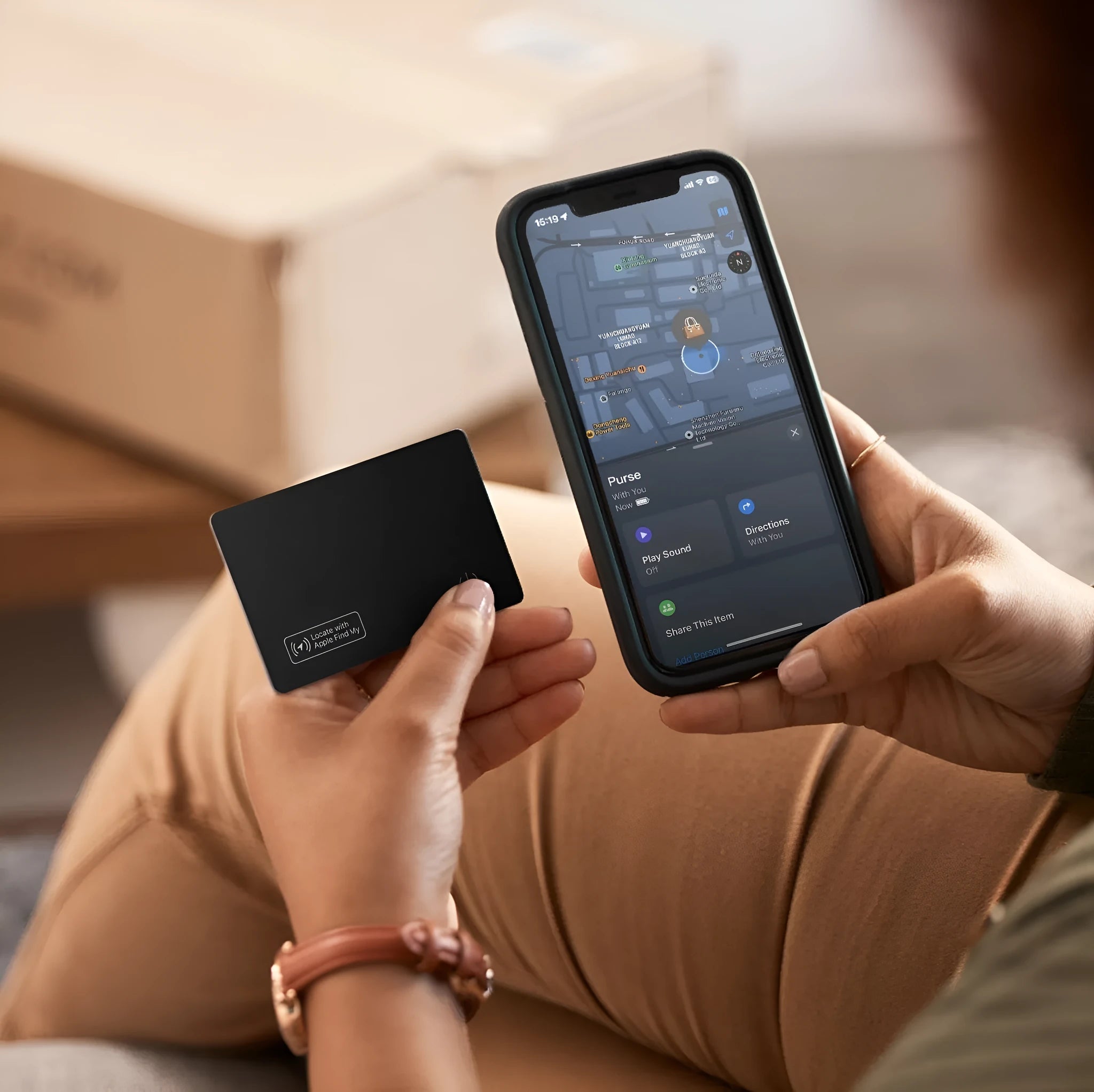 Black ultra-thin anti-loss alarm card for Apple devices next to a credit card for size comparison.