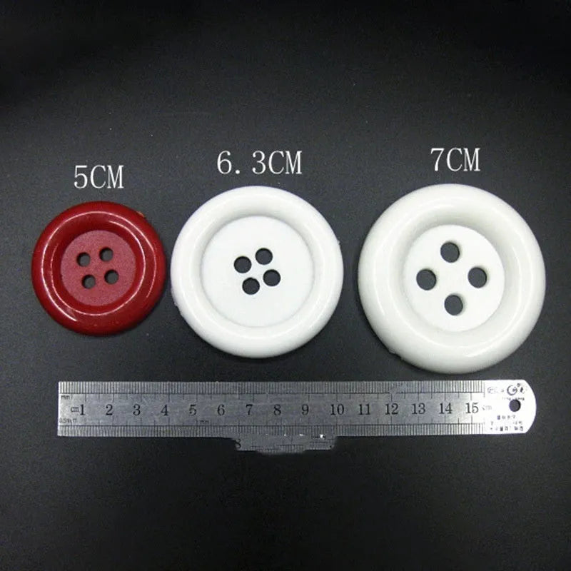 Oversized round edge plastic button with four holes in various colours and diameter sizes