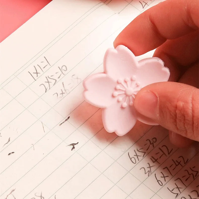Assortment of cherry blossom decorated erasers in various colours from a bulk pack.